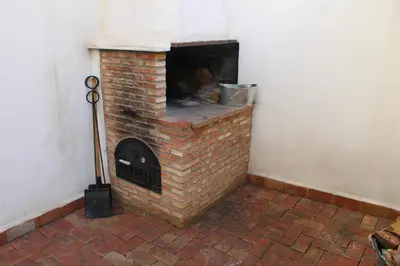 a brick fireplace in a corner of a room at Alojamiento turistico LaVid in Requena