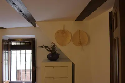 a room with a staircase with a window and a vase at Alojamiento turistico LaVid in Requena