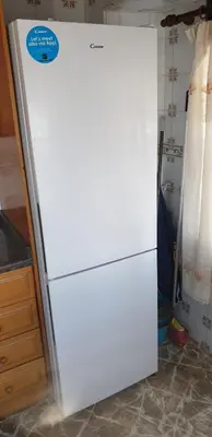 a white refrigerator with a sticker on it in a kitchen at Vacansis Habitaciones Privada en una Villa a un paso del Mar en Cullera in Cullera