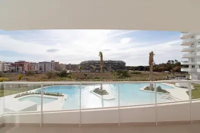 a view from the balcony of a building with a swimming pool at Global Vacacional, Apartamento para 5 personas con terraza y vistas a la piscina in Canet de Berenguer