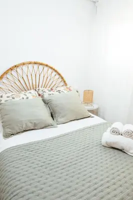 a bedroom with a large bed with two towels on it at Almar Collection Cullera AT in Cullera