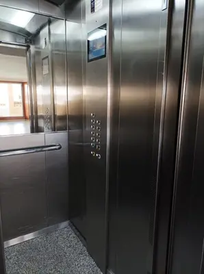a metal elevator in a room with a door at Almar Collection Cullera AT in Cullera