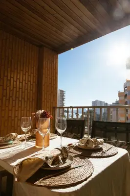 a table with a white table cloth and wine glasses at Almar Collection Cullera AT in Cullera