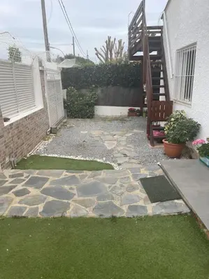 a stone patio with a bench and a house at Chalet Antonio&Ewa in La Eliana