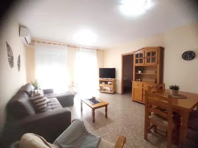 a living room with a couch and a table at Precioso apartamento en Puerto de Sagunto Valencia in Puerto de Sagunto