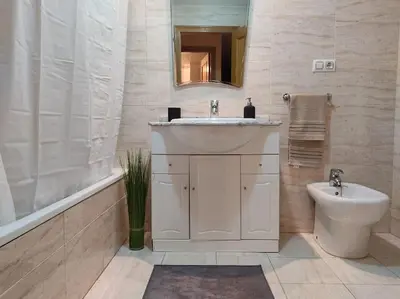 a bathroom with a sink and a toilet and a mirror at Precioso apartamento en Puerto de Sagunto Valencia in Puerto de Sagunto