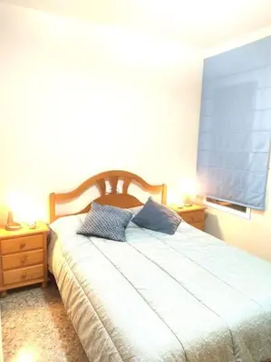 a bedroom with a bed with two pillows on it at Precioso apartamento en Puerto de Sagunto Valencia in Puerto de Sagunto