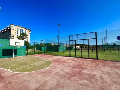 a basketball court with a net on a tennis court at Blue Beach Apartment+Oceanview+Private Parking in Valencia