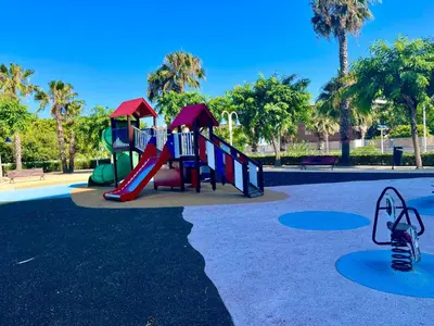 a playground with a slide in a park at Blue Beach Apartment+Oceanview+Private Parking in Valencia