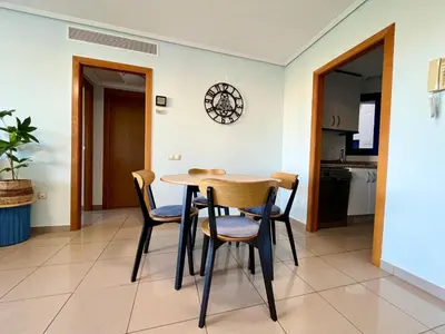 a kitchen and dining room with a table and chairs at Blue Beach Apartment+Oceanview+Private Parking in Valencia