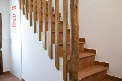 a staircase in a building with wooden railings at Casa Rural Lavadero en Teresa in Ríos de Abajo