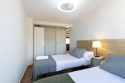 a bedroom with two beds and a lamp at Casa Rural Lavadero en Teresa in Ríos de Abajo