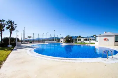 a large swimming pool with blue water at ESPACIO 15 - Primera Línea de Playa in Cullera