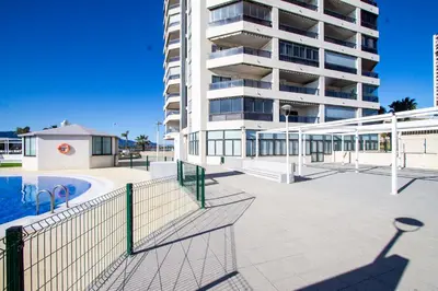 a large apartment building with a swimming pool and a building at ESPACIO 15 - Primera Línea de Playa in Cullera