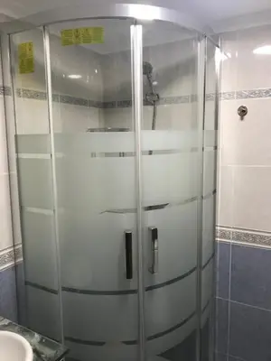 a shower with a glass door in a bathroom at Zerka Ayuntamiento in Valencia