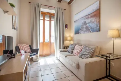 a living room with a couch and a tv at Zerka Ayuntamiento in Valencia