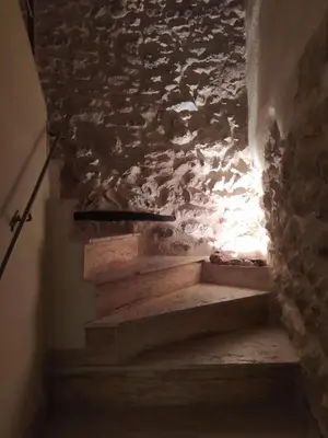 a set of stairs with a stone wall at Casa Rural Mirador de la Torre in Alcublas