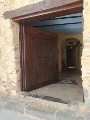 a large wooden door in a stone building at Casa Rural Mirador de la Torre in Alcublas