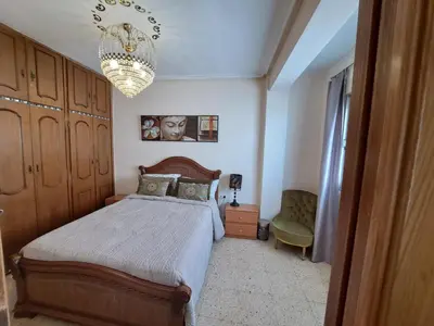 a bedroom with a bed and a chandelier at 3 bedroom Flat with WiFi in Valencia