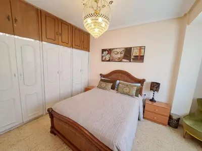 a bedroom with a bed and a chandelier at 3 bedroom Flat with WiFi in Valencia