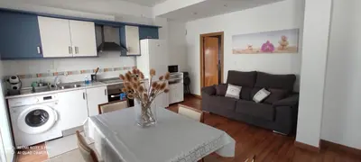 a kitchen and living room with a table and a couch at Mi pequeña terraza in Alaquas