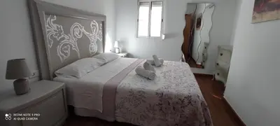 a bedroom with a bed with a teddy bear on it at Mi pequeña terraza in Alaquas