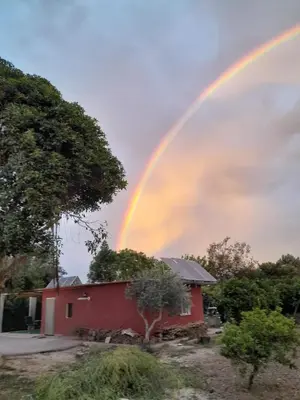 a rainbow over a house with a red house at Orange Blossom Finca Unique in Valencia