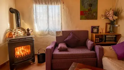 a living room with a couch and a stove at Orange Blossom Finca Unique in Valencia