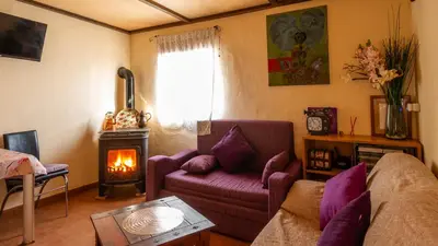 a living room with a couch and a wood stove at Orange Blossom Finca Unique in Valencia