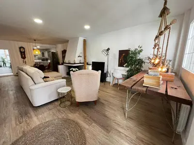 a living room with a table and a white couch at Casa Isabel aeropuerto feria Valencia in Partida de La Cañada