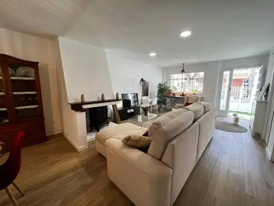 a living room with a couch and a fireplace at Casa Isabel aeropuerto feria Valencia in Partida de La Cañada