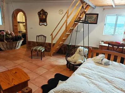 a bedroom with a dresser and a mirror and curtains at Buenas vistas y privacidad, tranquila y fresca villa en el bosque de Valencia con una magnífica piscina de 80m2 in Lliria
