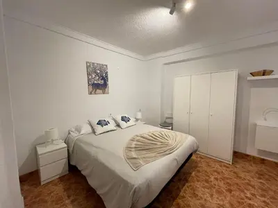 a white bedroom with a large bed with two pillows at Valencia Centro andando y Playa malvarrosa tranvía in Valencia
