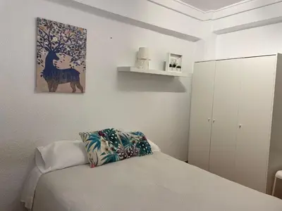 a bedroom with a bed and a painting on the wall at Valencia Centro andando y Playa malvarrosa tranvía in Valencia