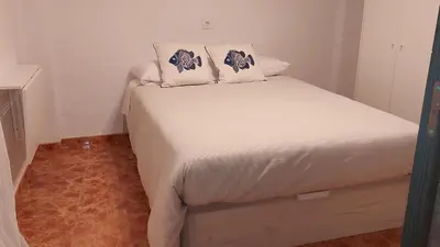 a white bed with two pillows on top of it at Valencia Centro andando y Playa malvarrosa tranvía in Valencia