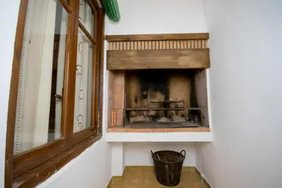 a fireplace in the corner of a room at Apartamento Paco entre Valencia y Castellón in Benafer