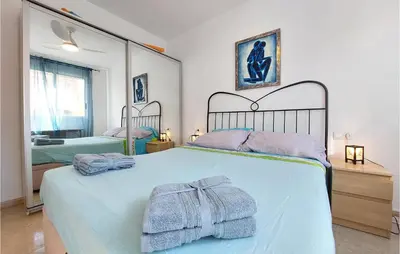 a bedroom with a bed with towels on it at Gorgeous Apartment In Playa De Moncofa in Moncófar