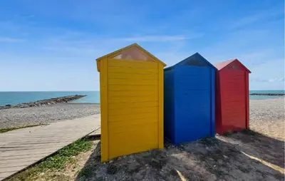 a row of colorful beach huts on the beach at Gorgeous Apartment In Playa De Moncofa in Moncófar