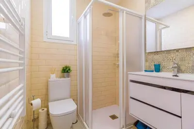 a bathroom with a toilet and a sink at Gran Vía by District Key in Valencia