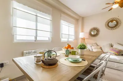 a dining room with a table and a couch at Gran Vía by District Key in Valencia