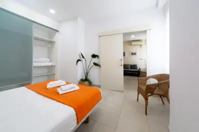 a bedroom with a bed and a dining room at Nest Silence in Valencia