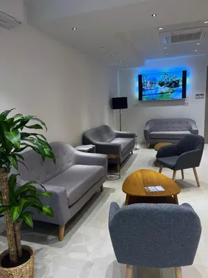 a waiting room with couches and chairs and a tv at Hotel BESTPRICE Valencia in Valencia