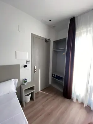 a bedroom with a bed and a door to a closet at Hotel BESTPRICE Valencia in Valencia