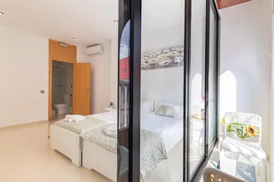a bedroom with a bed and a mirror at Grand Villa Valencia - 8 min to Center by Metro in Valencia