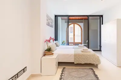 a bedroom with a bed and a large window at Grand Villa Valencia - 8 min to Center by Metro in Valencia
