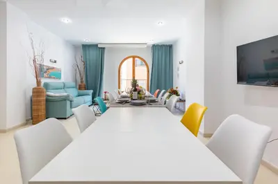 a dining room with a table and chairs at Grand Villa Valencia - 8 min to Center by Metro in Valencia