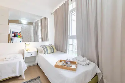 a small bedroom with a bed with a tray on it at Grand Villa Valencia - 8 min to Center by Metro in Valencia