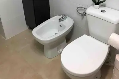 a bathroom with a white toilet and a bidet at LA CUEVA de TONI EL SECO in Paterna