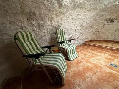 two green and white chairs sitting in a room at LA CUEVA de TONI EL SECO in Paterna