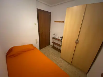 a bedroom with an orange bed and a closet at FLAT FAMILY NEAR BEACH GARDEN CENTER AND METRO in Valencia